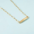 Detailed view of golden paperclip chain with a rectangular polished metal pendant - Gold