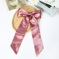 Elegant dusty pink satin bow hair clip with long ribbons on a minimalist wooden tray - Pink