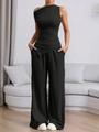 Detail of a chic black two-piece set featuring a one-shoulder crop top and wide-leg trousers - S / Black