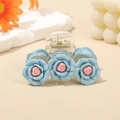 Transparent hair claw clip decorated with three light blue resin camellia flower charms - Blue