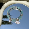 Blue and pearl beaded bracelet featuring a Cinnamoroll character charm on a mirror surface - S030-blue Bamboo-shaped Pearl And Cinnamon Dog Bracelet #sz230