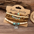 Bohemian stackable bead bracelet set with shell and cactus charms on wooden background - Cactus 5-piece Set