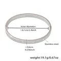 Detailed macro view of silver stainless steel bangle with inlaid crystals and hinge closure - Steel