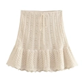 Detail of knit mini skirt featuring drawstring waist, hollow crochet patterns and ruffle hem - S / Skirts / Beige