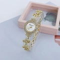 Close-up of golden clover bracelet watch with diamond-set bezel and white dial - Clover Bracelet Strap / Style C Gold