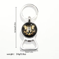 Macro shot of silver bottle opener keychain with H letter butterfly design and dimensions - Letter H