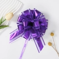 Detail of a purple organza and plastic pull bow for elegant gift box packaging - Purple