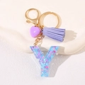 Letter Y keychain with purple tassel and glittering resin heart on a white pedestal - Letter Y