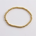 Polished gold beaded elastic bracelet for women featuring shiny metallic round beads - Gold