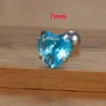 Macro shot of a 7mm heart-shaped blue zircon stud earring with silver titanium steel prongs - 7mm Silver Tone Blue Style (E1611)