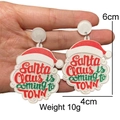 Detailed shot of Santa Claus acrylic earrings with festive typography and 6cm dimensions - Glitter White Santa