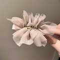 Detail of elegant champagne oversized chiffon flower hair clip with golden metal grip - Khaki