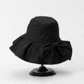 Detail of elegant black wide-brim sun hat with oversized bow and pleated texture - M(56-58cm) / Black