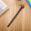 Deep brown gel pen with cute 3D silicone reindeer topper on a wooden desk - Brown Deer Coffee