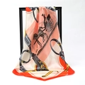 Silky satin square scarf featuring orange and beige carriage print on display rack - Carriage Saddle Snow Bud Base Orange Border (SD90-17-2)