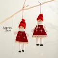 Set of two red knitted Christmas dolls hanging on branches with warm bokeh lights - Two-Piece Set / Red Skirt Girl