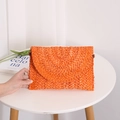 Orange woven straw clutch bag with a semi-circular flap and dense braided texture - Orange