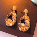 Irregular resin geometric earrings with gold trim and orange crystals on wood - Yellow