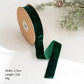 Macro detail of 2.5cm dark green velvet ribbon roll for Christmas DIY crafts and bows - 2.5cm x 10m / Dark Green