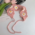 Close-up of pink crochet headband featuring white daisy patterns and woven texture - Pink Sunflower