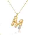 Detail of gold letter M pendant with hammered texture and sparkling white zircons - M