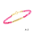 Detailed close-up of rose red chalcedony beads and gold plated metal accents on the bracelet - Rose Red Chalcedony Snowflake Plate