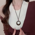Bohemian ceramic necklace with brown circular pendant and orange accent beads on rope - 58# Dark Wood Hollow Circle