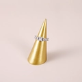 Silver row ring with square zircons on gold cone stand with beige background - Gold