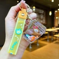 Detail of creative yellow milk tea cup keychain featuring a cute brown rabbit inside - Yellow Starbucks Airplane Cloth
