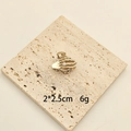 Golden alloy skeleton hand hair claw with a white pearl on a natural stone base - Hamsa Hand
