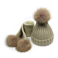 Detailed knit texture and soft faux fur pom-poms on winter hat and scarf set - Beige