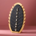 Bamboo stand displaying seven gold zircon pendant necklaces in various shapes - ZM010 Black PU Leather
