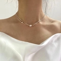 Elegant gold double-layered necklace featuring a round white freshwater pearl pendant - Layered Silver