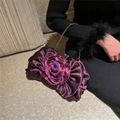 Detail of dark purple satin evening bag featuring a large 3D rose and silver chain strap - Purple