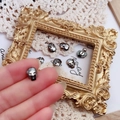 Detail of dark skull stud earring with faceted gunmetal finish and sparkling eye crystal - Mineral Black