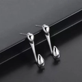 Macro shot of silver punk stud earrings with streamlined droplet design and mirror finish - Streamlined Water Drop Pair / Mirror Silver
