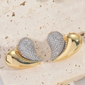 Macro shot of two-tone heart stud earrings with sparkling cubic zirconia on stone base - ES2739 Heart Dual-Tone