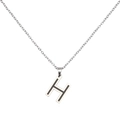 Macro detail of H-letter pendant necklace with silver finish and black enamel inlay - Letter H