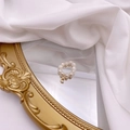 Macro detail of natural freshwater pearl ring with a golden letter C metal pendant charm - Letter C