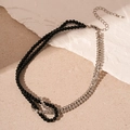 Detail of double-layer necklace with black crystal beads and silver rhinestone chain knot - Black Beaded Rhinestone Geometric Necklace