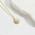 Golden sunburst necklace with central blue turquoise and sparkling cubic zirconia crystals - Snowflake