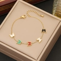 Golden butterfly bracelet with five colorful enamel charms on a beige jewelry display box - Butterfly Bracelet