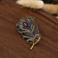 Macro detail of retro peacock feather brooch with colorful zircons and golden base - 5.6x3.6cm / Feather-5 (Antique Gold Colorful Diamonds Red-Brown Gem)