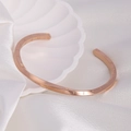 Detailed view of rose gold C-shaped cuff bracelet with engraved Roman numerals on silk - 55*70mm / Rose Gold