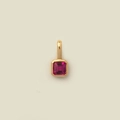 Rectangle ruby zircon pendant in golden finish on a clean minimalist cream background - July Pendant (Ruby Red)