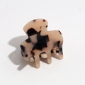 Detail of amber tortoiseshell hair claw clip with gradient resin texture and polished finish - Leopard Brown