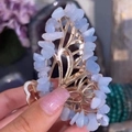 Close-up of golden butterfly hair clip with light blue natural crystal stones - Blue Lace Agate Gold Butterfly