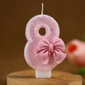 Pink glitter number 8 birthday candle with a cute bow decoration for parties - Number 8