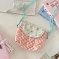 Detail van de roze gewatteerde crossbodytas met groene bloemenflap op het bureau - Salt Style Konijntje