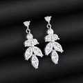 Macro detail of silver floral earrings with marquise-cut stones on black leather - Earrings / Platinum Plated Earrings